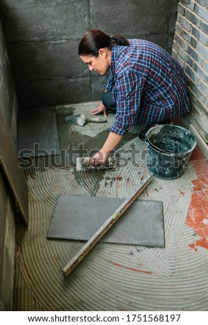 Similar – Image, Stock Photo Female mason laying a new tile floor