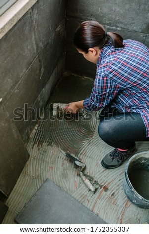 Similar – Image, Stock Photo Female mason laying a new tile floor