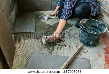 Similar – Image, Stock Photo Female mason laying a new tile floor