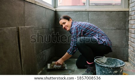 Similar – Image, Stock Photo Female mason laying a new tile floor