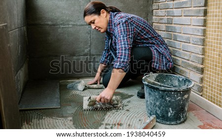 Similar – Image, Stock Photo Female mason laying a new tile floor