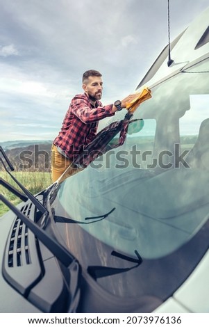 Similar – Image, Stock Photo Man cleaning motorhome glass outdoor