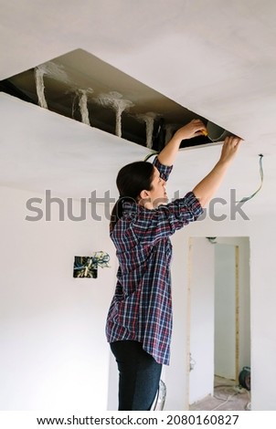 Woman preparing extractor hood installation on kitchen ceiling ストックフォト © 