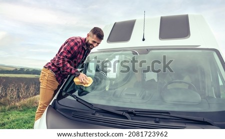 Similar – Image, Stock Photo Man cleaning motorhome glass outdoor