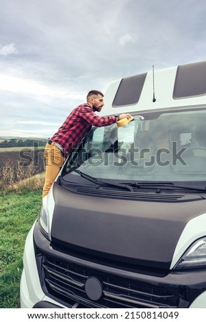 Similar – Image, Stock Photo Man cleaning motorhome glass outdoor