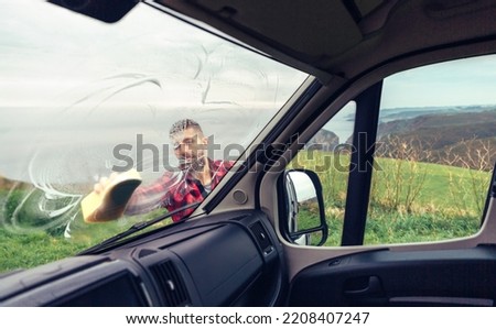 Similar – Image, Stock Photo Man cleaning motorhome glass outdoor