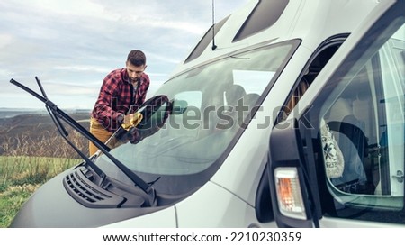 Similar – Image, Stock Photo Man cleaning motorhome glass outdoor