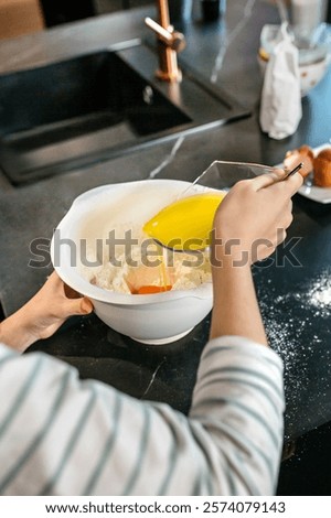 Similar – Image, Stock Photo Faceless woman preparing eggs with whisk in kitchen