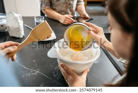 Similar – Image, Stock Photo Faceless woman preparing eggs with whisk in kitchen