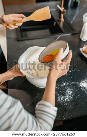 Similar – Image, Stock Photo Faceless woman preparing eggs with whisk in kitchen