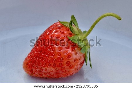 Similar – Image, Stock Photo Single strawberry on a spoon. Ripe strawberry on pink