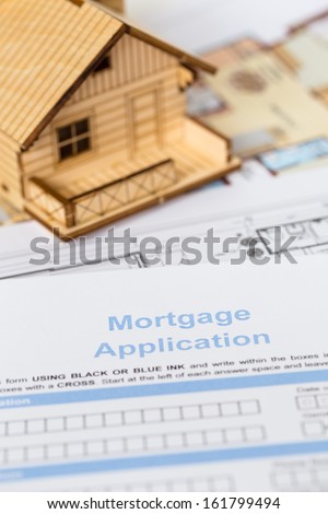 House mortgage application with model house and construction plan