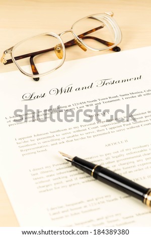 Last will on cream color paper with glasses and pen concept for legal document