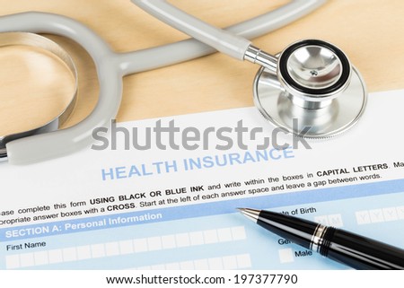 Health insurance application form with pen and stethoscope concept for life planning