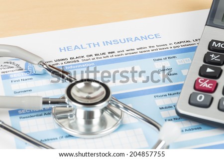 Health insurance application form with calculator and stethoscope concept for life planning