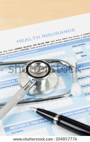 Health insurance application form with pen and stethoscope concept for life planning