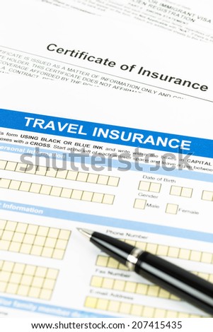 Travel insurance application form with pen