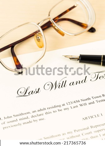 Last will on cream color paper with glasses and pen concept for legal document
