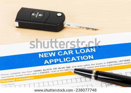 Car loan application with car key and pen