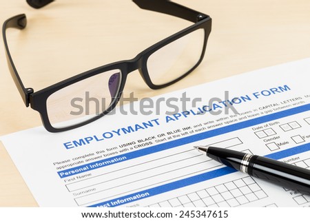 Employment application form with pen and glasses concept job applying