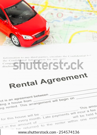 Car rental agreement on map, document is mock-up
