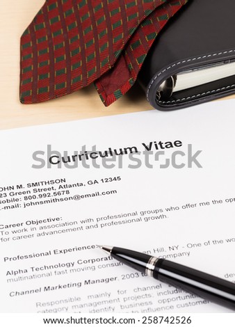Curriculum vitae with pen, organizer and neck tie; CV is mock-up