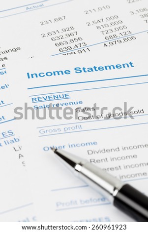 Income Statement report with pen; document is mock-up