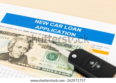 Car loan application with car key and dollar banknote; document is mock-up