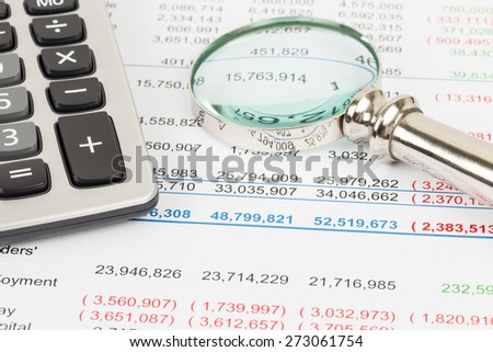 Financial Statement report with calculator and magnifier; document is mock-up