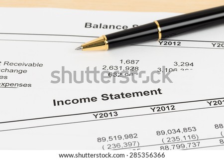 Income statement financial report with pen