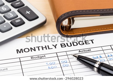 Home budget planning sheet with pen and calculator