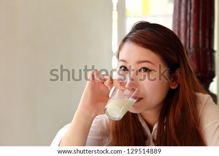 Beautiful asian woman drink a milk