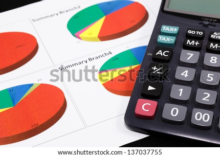 Business report  graph with pen and calculator