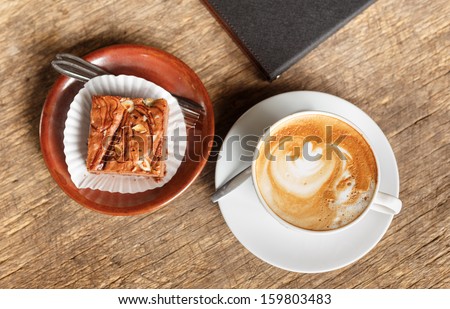hot coffee with cake on grunge wood background