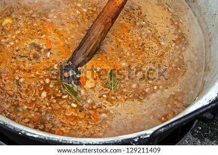 Bean soup prepared in a large pot, at a fair with traditional romanian food.