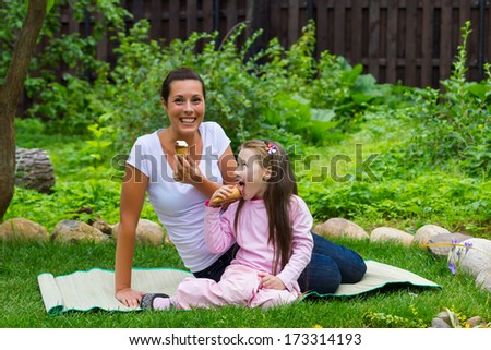 Mother and daughter eating ice-cream