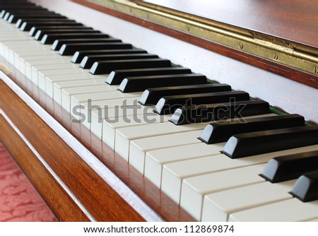 Piano key closeup on a wooden piano