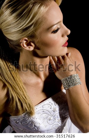 Beautiful bride against a black background wearing a diamond bracelet