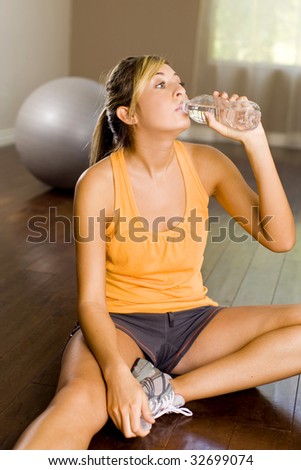 Young woman stretching at a gym