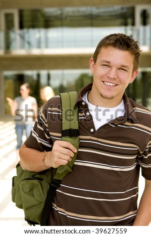 Young man at school holding a book bag