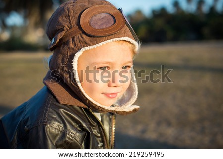 Cute little boy pilot wearing aviator hat and jacket