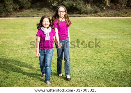 Cute little sister in a park outside