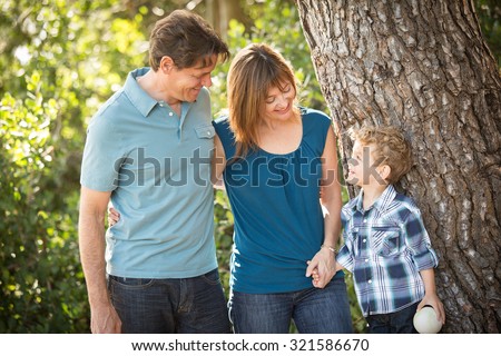 Happy young family standing outside