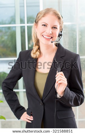 Business woman talking on a head set in her office
