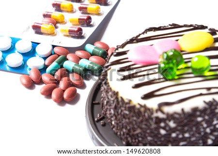 chocolate cake and many medicine on white background
