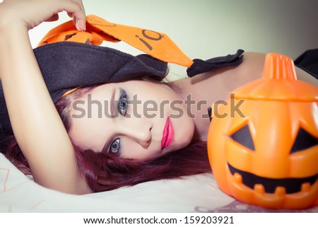 Women\'s Halloween hat and pumpkin in concept halloween