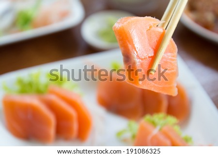 Salmon sashimi on white dish, food background