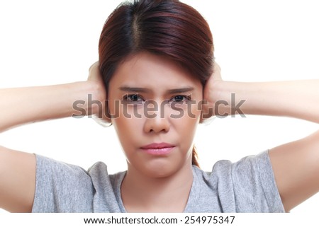 Beautiful young woman is touching her ear and closing her ears from noise. Health concept.