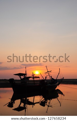 Fishing boat silhouette at sunset Thailand