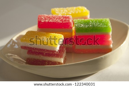 Different fruit-paste candies on a small plate in a sunlight